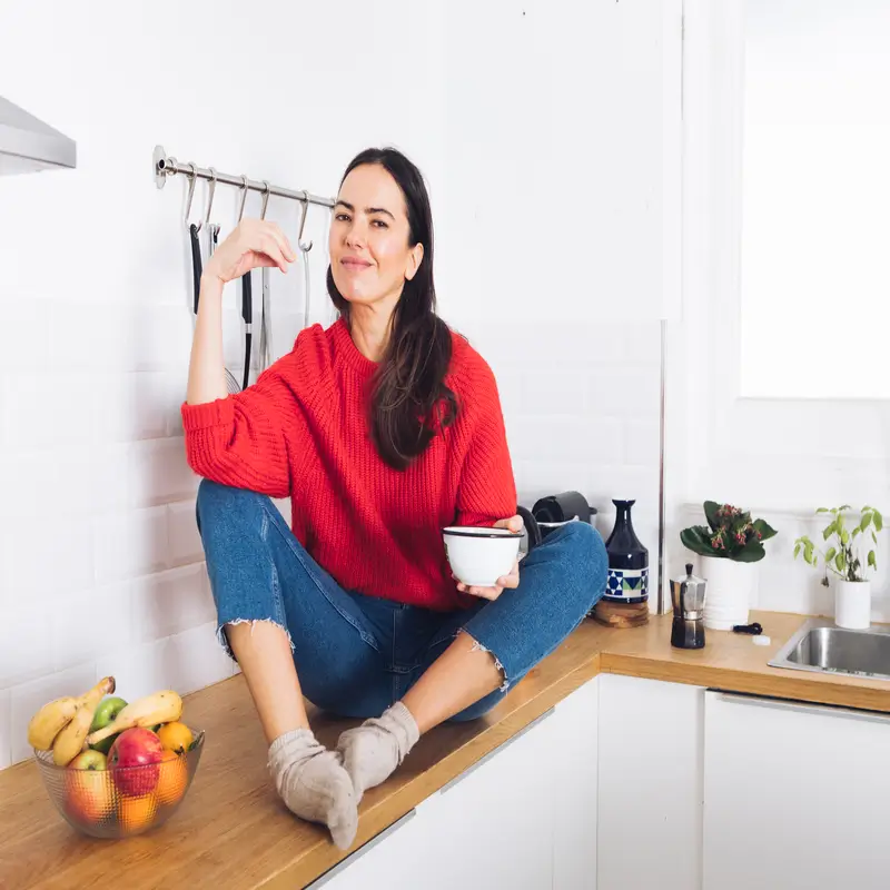 Home 1 Jessy from CookSimpleToday sitting on her kitchen counter enjoying a homemade snack.